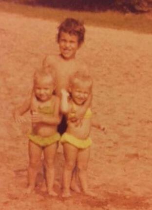 Michael Silva with his twin sisters.